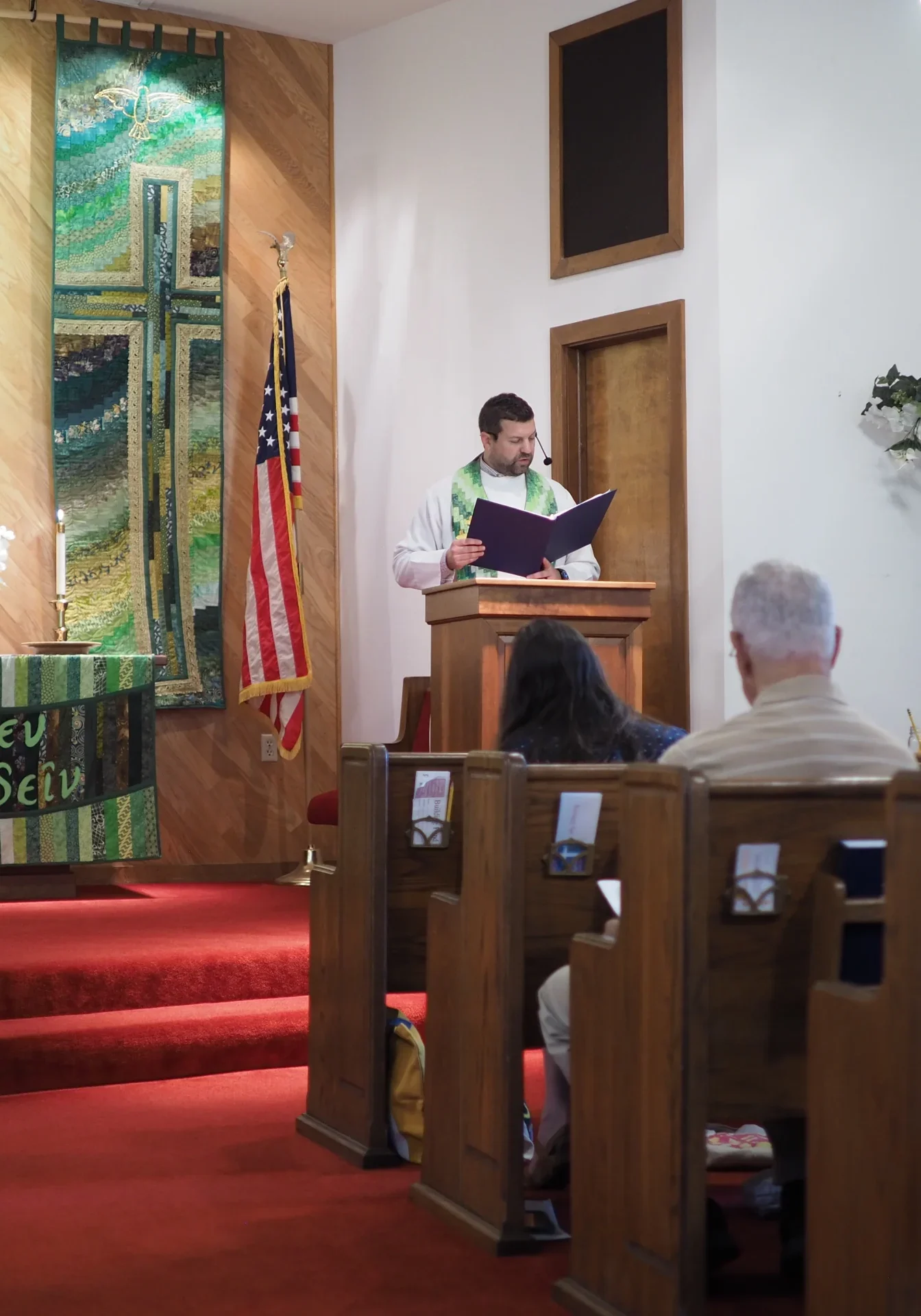 Pastor reading from the pulpit during a church worship service